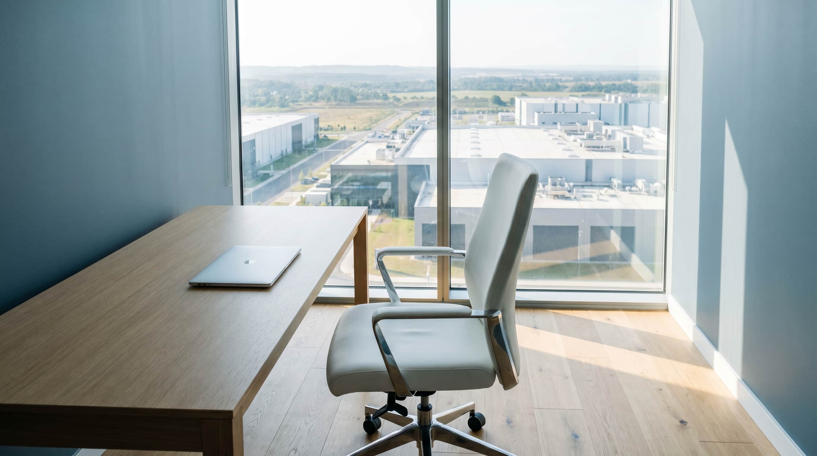 A sparse new executive office at morning — the chair is different, the strategy on the desk is the same